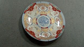 A late 19th/early 20th century Imari charger, the central blue roundel enclose by quails under mille