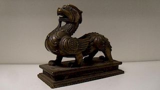 A 20th century bronze figure of a bixie, the mythical beast walking across a rectangular base roarin