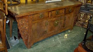 A 19th century altar table, the narrow ends of the rectangular top with raised cylinder scrolls abov