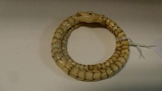 An ivory snake bracelet, the graded flower shaped links each with four petal tops interlinking to fo
