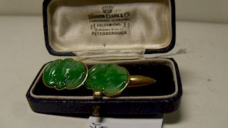 A pair of gold mounted jadeite cufflinks, the mottled emerald green stone carved in the form of bats