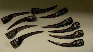 Ten 19th century enamelled finger nail guards, the curved and rounded sides with coloured flroal dec