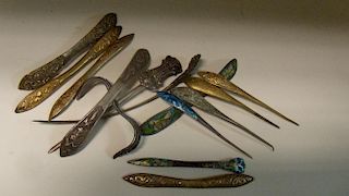 Fourteen hair pins and pieces, two with ornamental ends to pin shafts in white metal, four of spatul