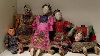 Five late 19th/early 20th century dolls, the two females and one male with formal dress and headress