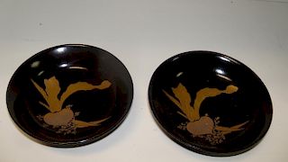 Two late 19th/early 20th century black lacquer dishes, each painted in gold lacquers with two carrot