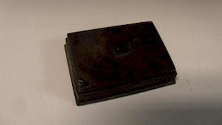 A 19th century bronze water dropper, the squat rectangular shape with a spout at one corner, 5cm (2