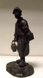 A Meiji period (1868-1912) bronze figure of a singing man standing with a lamp in one hand and a boo