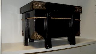 A 20th century black lacquer box, the rectangular form supported on six legs, the corners mounted in