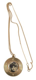 14 Karat Gold Pendant Locket and Chain, total weight 12 grams, chain length 18 inches, locket diameter 1 1/2 inches.