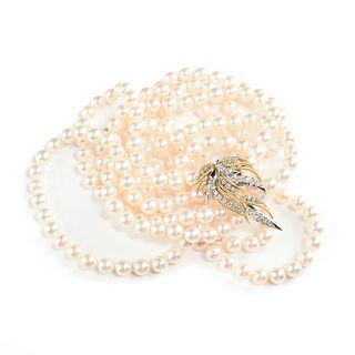 A DOUBLE STRAND PEARL NECKLACE WITH A 14K YELLOW GOLD AND DIAMOND LEAF CLASP,