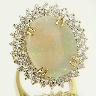 Lady's Large 9.0 Carat White Opal, 3.15 Carat Round Cut Diamond and 14 Karat Yellow Gold Ring.