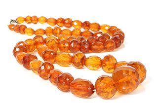 A single row faceted cognac amber bead necklace,