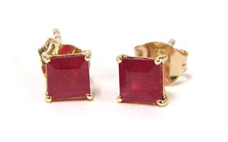 A pair of gold single stone fracture filled ruby stud earrings,