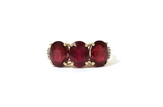 A gold three stone fracture filled ruby ring,