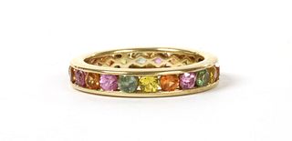 A gold varicoloured sapphire full eternity ring,
