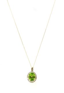 A gold peridot and diamond cluster pendant,
