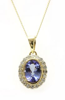 A gold tanzanite and diamond cluster pendant,