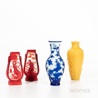 Four Peking Glass Vases, China, 19th to 20th century, a yellow baluster-form vase with archaic-style taotie designs; an oviform blue ov