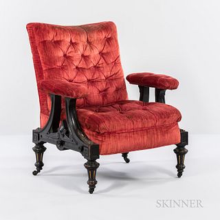 Renaissance Revival Ebonized and Upholstered Armchair, tufted red upholstery, carved foliate and Greek key frame with turned legs termi