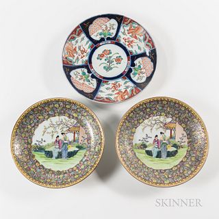 Three Export Porcelain Chargers, China, 20th century, a pair of famille rose chargers, depicting a garden scene with figures in the lob