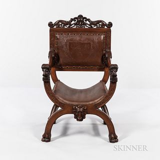 Victorian Savonarola-style Armchair, shaped back carved with mask and leaves, armrests carved with roaring lions, legs set on claw-carv
