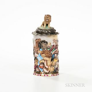 Capodimonte-style Porcelain Tankard, 19th century, polychrome enamel decorated in high relief, lion finial to a silver framed cover, ht