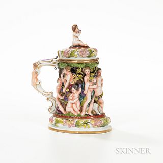 Capodimonte-style Porcelain Tankard, 19th century, polychrome enamel decorated in high relief with classical figures, an infant finial