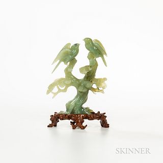 Hardstone Carving of Birds, China, perched on pine branches, green stone mottled with darker green spots, with a conforming wood stand,