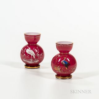 Pair of Cranberry Cased Glass Vases, late 19th to early 20th century, enameled decoration, one depicting a heron in a waterscape, the o
