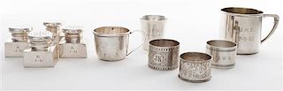 * A Collection of Ten Silver Table Articles, , comprising three napkin rings, four casters and three small mugs, each with vario