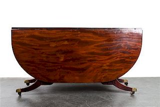A Regency Style Mahogany Dropleaf Table. Height 28 1/2 x width 54 x depth 22 1/4 inches.