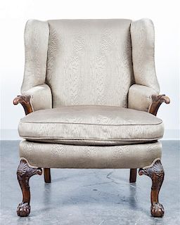 An Upholstered Wingback Armchair. Height 41 3/4 inches.
