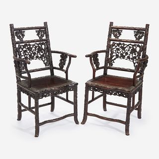 An unusual pair of Chinese carved hardwood armchairs 中国硬木扶手椅一对 Late 19th to early 20th Century 十九世纪晚期至二十世纪早期
