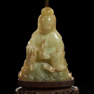 A Chinese carved mottled celadon jade figure of Guanyin, mounted as a lamp 玉雕观音改装台灯
