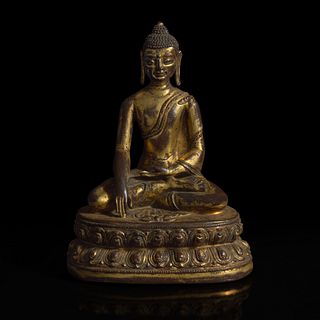 A Himalayan gilt copper alloy figure of Buddha Akshobhya 喜马拉雅铜鎏金阿閦佛造像 14th Century or earlier 十四世纪或更早