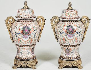 PAIR OF ENAMEL DECORATED PORCELAIN URNS AND COVERS