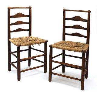 A pair of Arts and Crafts oak chairs,