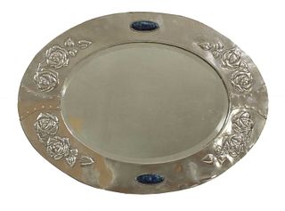 An Arts and Crafts silver-plated oval wall mirror,