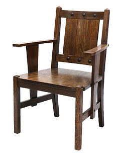 An Arts and Crafts oak elbow chair,