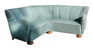 A turquoise upholstered corner settee,