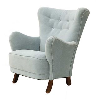 A light blue upholstered armchair