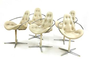 A set of five white faux leather chairs,