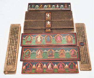 Two Tibetan Books
each having carved wood covers mounted with metal seated buddha figures
hand written and painted interior