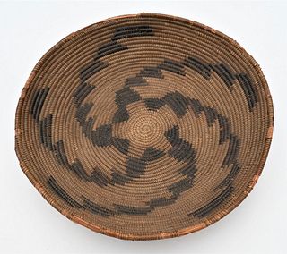 American Indian Coiled Basket
having black geometric designs 
(some rim damage)
height 3 inches, diameter 15 inches
Provenance: Estate of Bruce Sasall