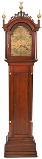 Walter H. Durfee Tall Case Grandfather Clockhaving shaped crest and brass finials, single door opening to brass dial, inlaid mahogany case with flute