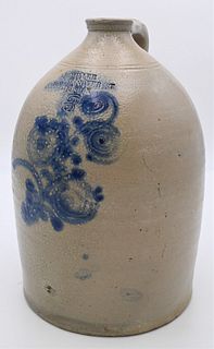 J. Miller Stoneware 
three gallon jug marked 189 Hanover Street, Boston
with blue decorated flowers
height 15 1/2 inches
Provenance: Estate of Bruce S