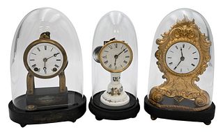 Three Dome Shelf Clocks
dome clock with brass works resting on milk glass pedestal base;
French embossed brass clock with enameled dial;
brass marked 