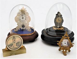 Group of Four Miniature Clocks
to include brass and metal with swing pendulum under dome; mother of pearl with brass works and swing pendulum under do