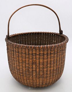 Nantucket Swing Handle Basket 
having minute damage near bottom
height 8 inches plus handle, diameter 11 1/4 inches
Provenance: Fifty Year Personal Co