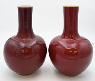 Pair of Chinese Bottle Form Oxblood Langyao Vases
one with a gilt rim and base, both marked with six character Kangxi Reign mark character to undersid